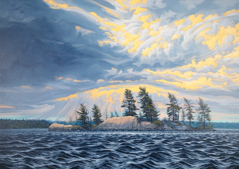 Photo of Whitefish Bay, South East (2021) by Randolph Parker. Image shoes a dark storm on the horizon with yellow rays of sun seeping in through the clouds. An island stands in the middle of the painting, with large evergreen trees bending in the forceful wind. Behind the island in the distant background, a forest of evergreens also bend to the wind in unison. Below the island, the dark lake churns and waves peak up towards the horizon. 